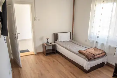 a small bedroom with a bed and a window at Apartments Kuca Aleksic in Niš