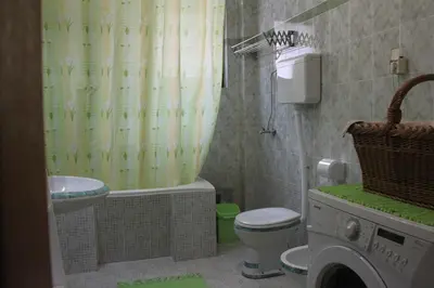 a bathroom with a sink toilet and a shower curtain at Boulevard Garden House - Free and save parking in the locked yard in Ćuprija