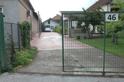 a gate with the number on it next to a house at Boulevard Garden House - Free and save parking in the locked yard in Ćuprija