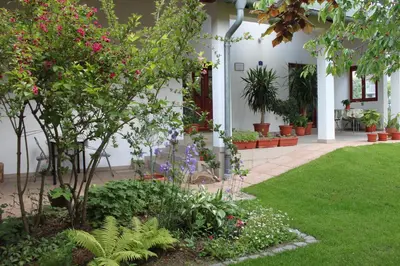 a garden with flowers and plants in a building at Boulevard Garden House - Free and save parking in the locked yard in Ćuprija