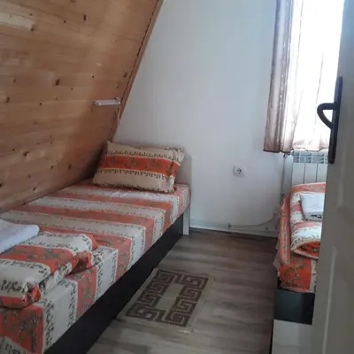 a small room with a couch and a window at Vili Bilyana in Crni Vrh