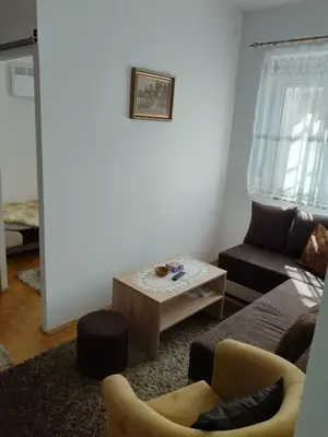 a living room with a couch and a coffee table at Apartman Krstić in Vrnjačka Banja