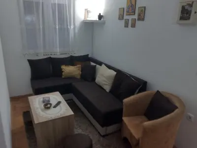 a living room with a couch and a chair at Apartman Krstić in Vrnjačka Banja