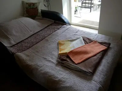 a bed with two pillows on top of it at Sokobanja Apartmani in Soko Banja