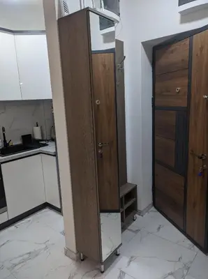 a kitchen with two wooden cabinets in a room at Sokobanja Apartmani in Soko Banja