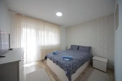 a bedroom with a bed with blue towels on it at Apartman DIAMOND-LUX in Jagodina