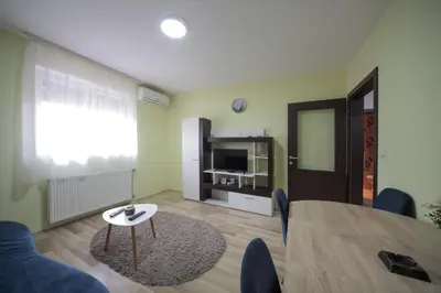 a living room with a table and a couch and a television at Apartman DIAMOND-LUX in Jagodina
