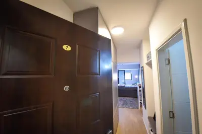 a hallway with a door and a room at Urban Apartment in Niš
