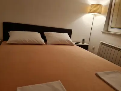 a large bed with two pillows on top of it at Apartman Veselinovic Free PARKING in Vranje