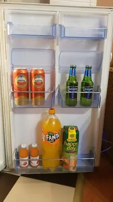 an open refrigerator filled with drinks and juice at Apartman Veselinovic Free PARKING in Vranje