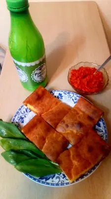 a plate of waffles on a table with a green bottle at Guest House Green view in Pirot