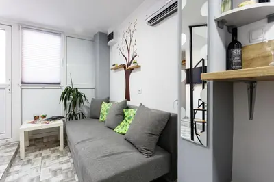 a living room with a couch and a table at SB centar apartmani in Niš