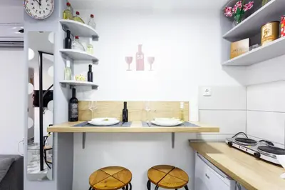a kitchen with two stools and a counter top at SB centar apartmani in Niš