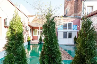 a house with a swimming pool with trees in it at SB centar apartmani in Niš