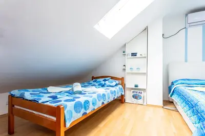 a bedroom with two beds in a attic at SB centar apartmani in Niš