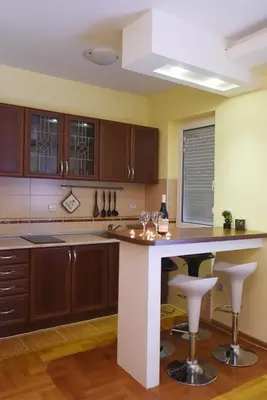 a kitchen with a island with bar stools at Apartment Matovic in Vrnjačka Banja