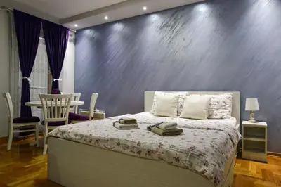 a bedroom with a bed with towels on it at Apartment Marijana in Vrnjačka Banja