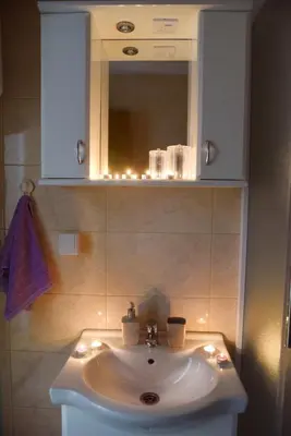 a bathroom with a white sink and a mirror at Apartment Marijana in Vrnjačka Banja