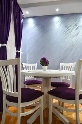 a dining room with a white table and chairs at Apartment Marijana in Vrnjačka Banja