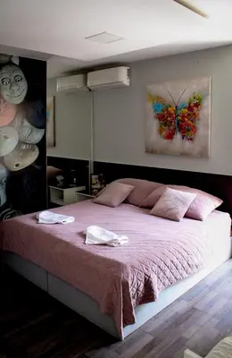 a bedroom with a large bed with pink sheets at Vladana LUX App in Kruševac