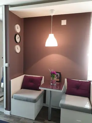 a room with two chairs and a table and a lamp at Vladana LUX App in Kruševac