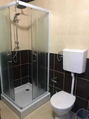 a bathroom with a toilet and a glass shower at Vladana LUX App in Kruševac