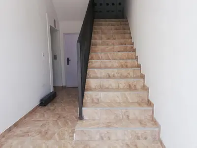 a staircase in a house with wooden floors at Laguna apartman 2 in Niš