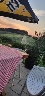 a table and a table and a picnic table and a table and a table at Resavsko Etno Selo in Despotovac