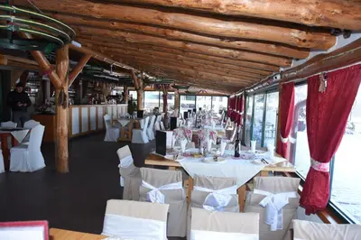a dining room with white tables and white chairs at Resavsko Etno Selo in Despotovac