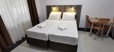 a bedroom with a bed with two pillows on it at Apartments Banjica in Soko Banja