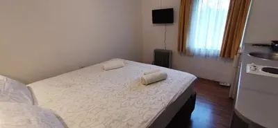 a bedroom with a bed with two towels on it at Apartments Banjica in Soko Banja