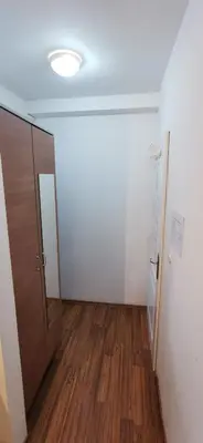 an empty room with a door and wooden floor at Apartments Banjica in Soko Banja