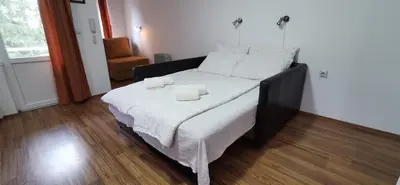 a bedroom with a bed with two towels on it at Apartments Banjica in Soko Banja