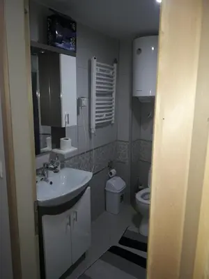a small bathroom with a sink and a toilet at Stefan apartmani in Kopaonik