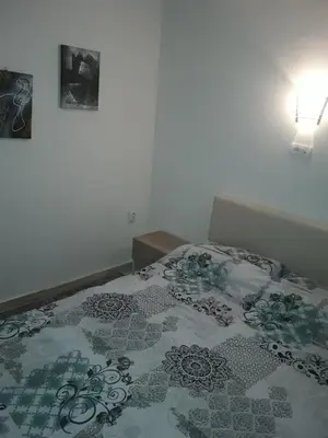 a bedroom with a bed with a comforter on it at Stefan apartmani in Kopaonik