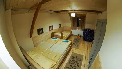 a view of a room with a bed in a house at Golema Reka in Crni Vrh