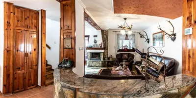 a living room with a large stone counter in a house at Vila Seka in Kopaonik