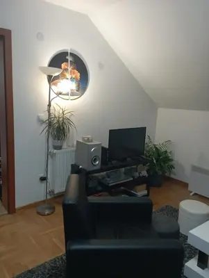 a living room with a couch and a desk with a computer at Jasna Apartman in Vrnjačka Banja