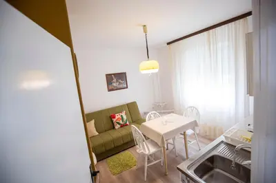 a living room with a couch and a table at Apartmani Didić in Soko Banja