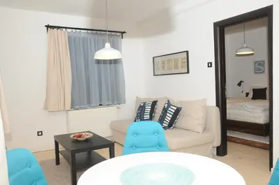 a living room with a couch and a table and a bed at AS Apartments in Kopaonik