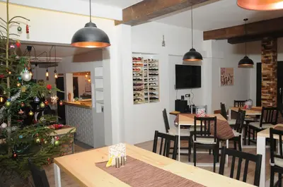 a restaurant with a christmas tree and tables and chairs at AS Apartments in Kopaonik