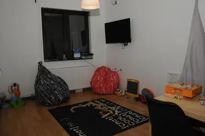 a room with a table and a window and a rug at AS Apartments in Kopaonik