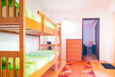 a bedroom with two bunk beds and a hallway at Apartmani Slavica in Jagodina