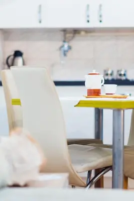 a table with a coffee cup on a yellow table at Apartmani Slavica in Jagodina
