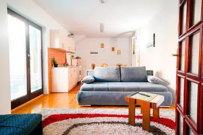 a living room with a couch and a table at Apartmani Slavica in Jagodina