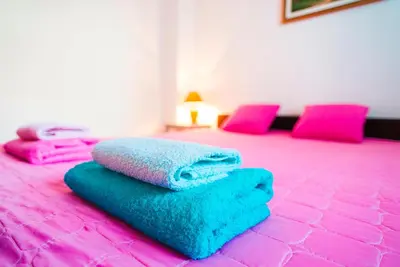 a pile of towels sitting on top of a bed at Apartmani Slavica in Jagodina