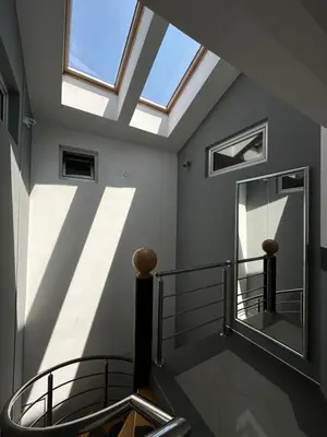 a skylight in a room with a mirror and stairs at APARTMANI LAVAZZA in Vlasotince