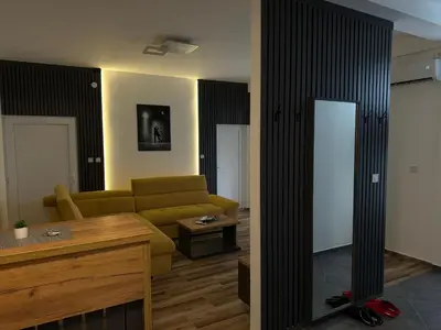 a living room with a couch and a table at APARTMANI LAVAZZA in Vlasotince