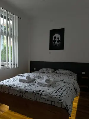 a bedroom with a bed with towels on it at APARTMANI LAVAZZA in Vlasotince