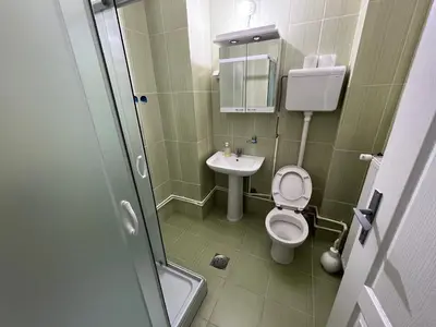 a small bathroom with a toilet and a sink at Apartments and Rooms Vicko in Brzeće